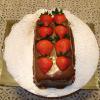 Chocolate mousse  covered in chocolate glaze and topped with fresh strawberries.